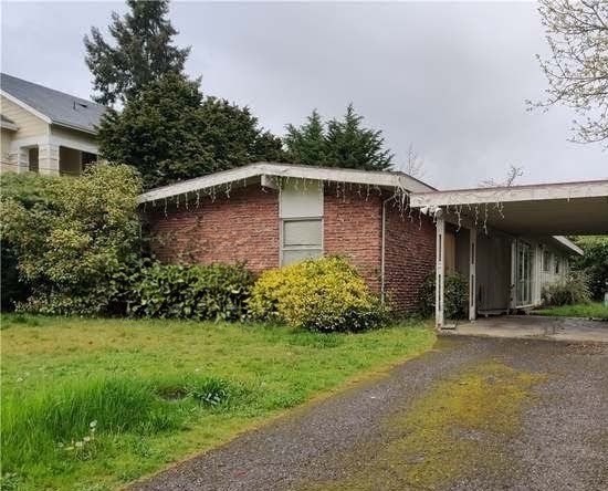 Before &mdash; a neglected lawn and overgrown yard