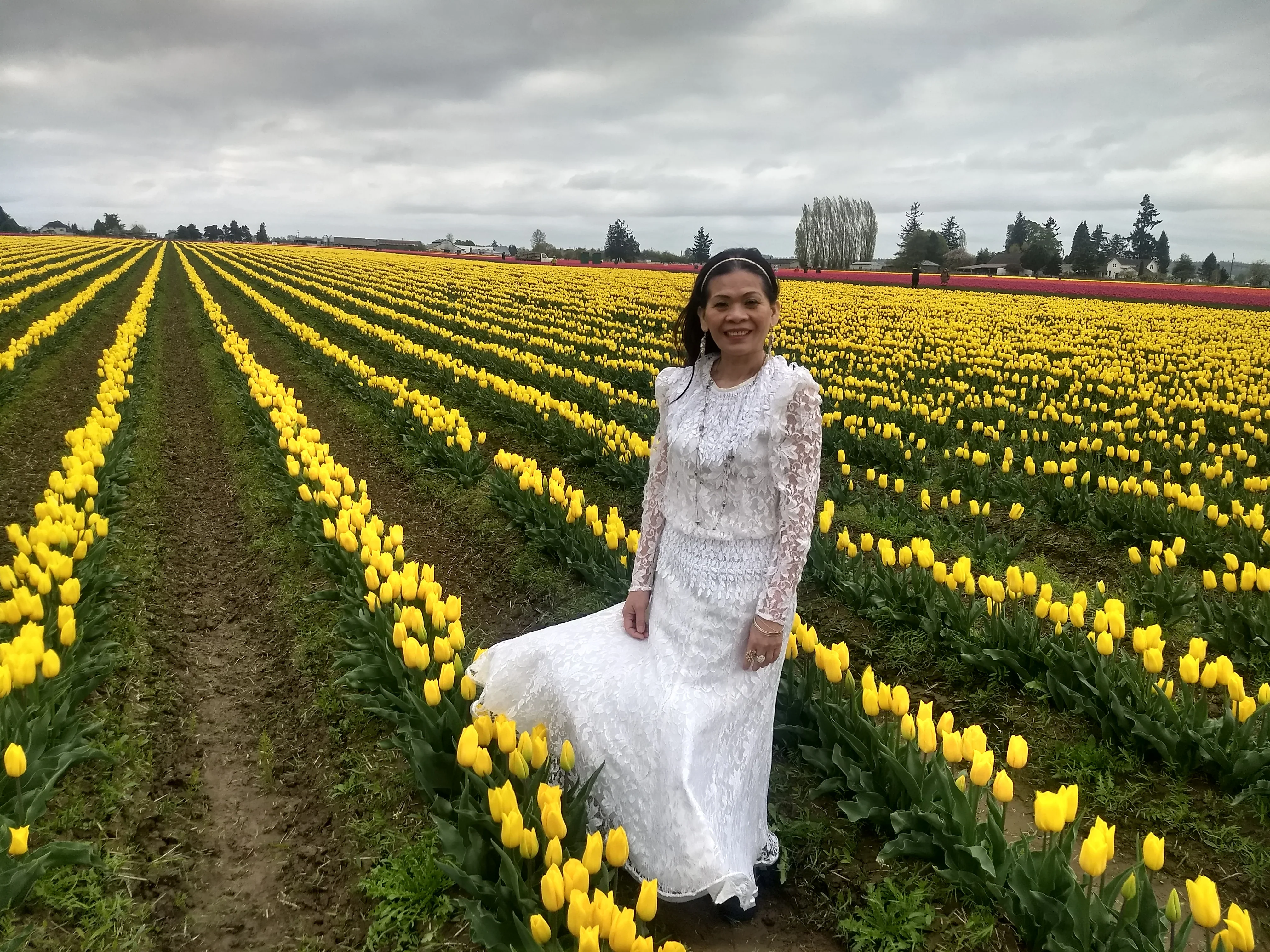 PhyTu's founder's mother in a field of yellow tulips