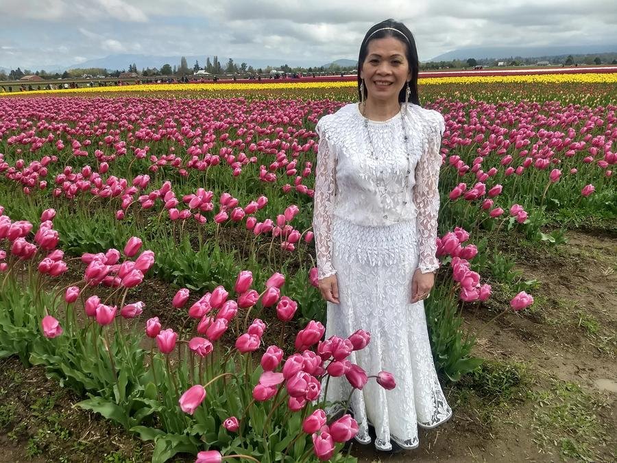 Woman in pink tulip field — PhyTu founder's mother